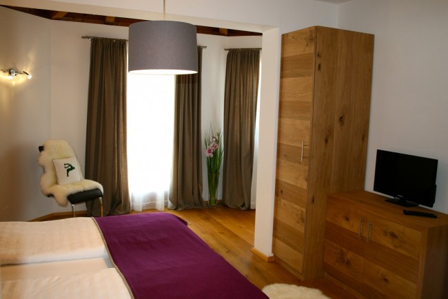 Schlafzimmer mit Flat-TV im Appartement Central Room