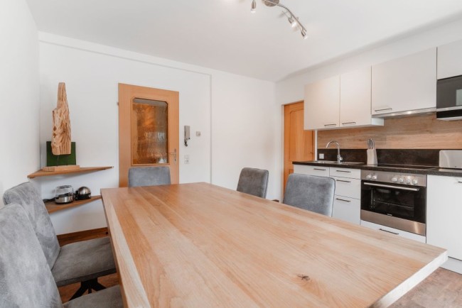K&uuml;che mit gro&szlig;em Esstisch und Balkon